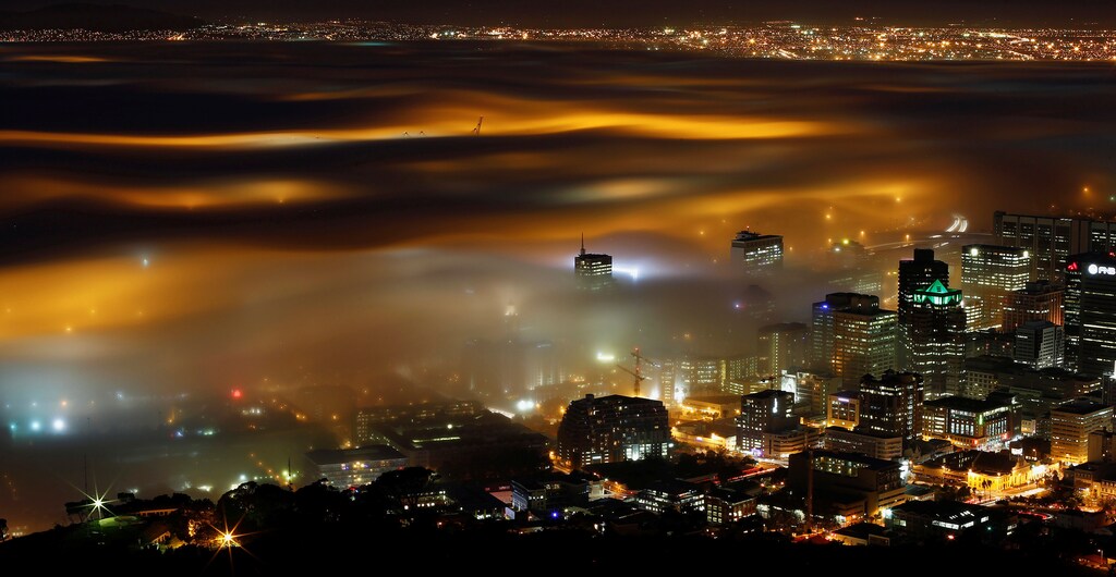 Seasonal fog is illuminated by the lights of Cape Town harbour as the city prepares for the start of the southern hemisphere winter, May 8, 2012. REUTERS/Mike Hutchings/File Photo GLOBAL BUSINESS WEEK AHEAD PACKAGE - SEARCH "BUSINESS WEEK AHEAD JUNE 6" FOR ALL IMAGES - RTSG568