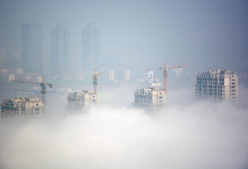 Buildings under construction are seen during a hazy day in Rizhao, Shandong Province, China, March 15, 2016. REUTERS/Stringer ATTENTION EDITORS - THIS PICTURE WAS PROVIDED BY A THIRD PARTY. THIS PICTURE IS DISTRIBUTED EXACTLY AS RECEIVED BY REUTERS, AS A SERVICE TO CLIENTS. CHINA OUT. NO COMMERCIAL OR EDITORIAL SALES IN CHINA. TPX IMAGES OF THE DAY - RTSAG6R