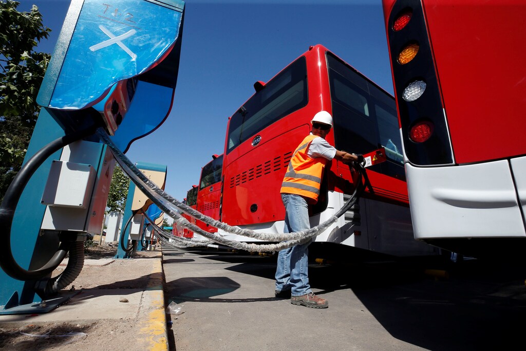 A man plugs an electric bus, manufactured by China's BYD, as part of the new fleet of electric buses for public transport in Santiago, Chile November 28, 2018. Picture taken November 28, 2018