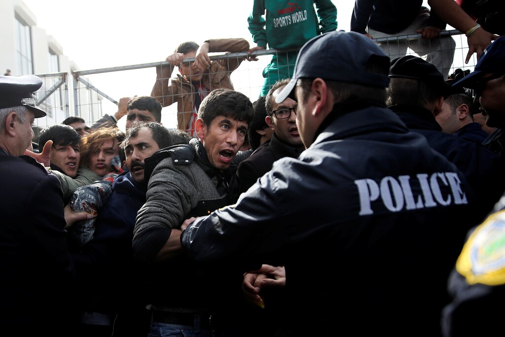 An Afghan migrant shouts at a police officer as refugees and migrants, most of them Afghans, argue with police as they block the entrance of the refugee camp at the disused Hellenikon airport, in Athens, Greece, February 6, 2017. REUTERS/Alkis Konstantinidis TPX IMAGES OF THE DAY - RTX2ZTMW