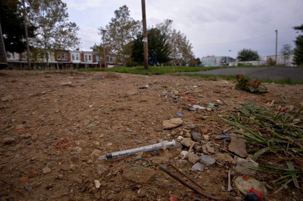 A needle used for shooting heroin and other opioids litters the ground in a park in the Kensington section of Philadelphia, Pennsylvania, U.S. October 26, 2017. REUTERS/Charles Mostoller - RC1F2F347F00