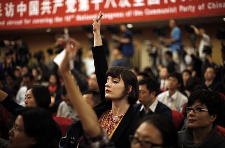 A foreign journalist raises her hand to ask a question during a news conference with Jiang Weixin, minister and secretary of the CPC Leadership Group of the Ministry of Housing And Urban-Rural Development, during the 18th National Party Congress (NPC) in Beijing November 12, 2012. At the last congress in 2007, top officials took one-on-one interviews, overseas reporters were encouraged to ask questions on whatever subject they wished and government media handlers went out of their way to be helpful, hoping to burnish China's global image ahead of the 2008 Olympic Games. This year, while economic officials and business leaders have generally been willing to talk, provincial leaders and rising political stars have largely shunned international media, and in some cases tried to avoid talking in public at all. REUTERS/Carlos Barria (CHINA - Tags: POLITICS MEDIA)