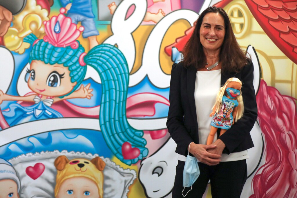 Marie-Eve Rougeot, chief executive officer of Spanish toy maker Famosa, poses as she holds a Nancy doll, one of Spain's most beloved toys, wearing a protective mask, during an interview with Reuters at company's headquarters in Madrid, Spain, November 30, 2020. Picture taken November 30, 2020. REUTERS/Sergio Perez - RC2XIK9DMQB6