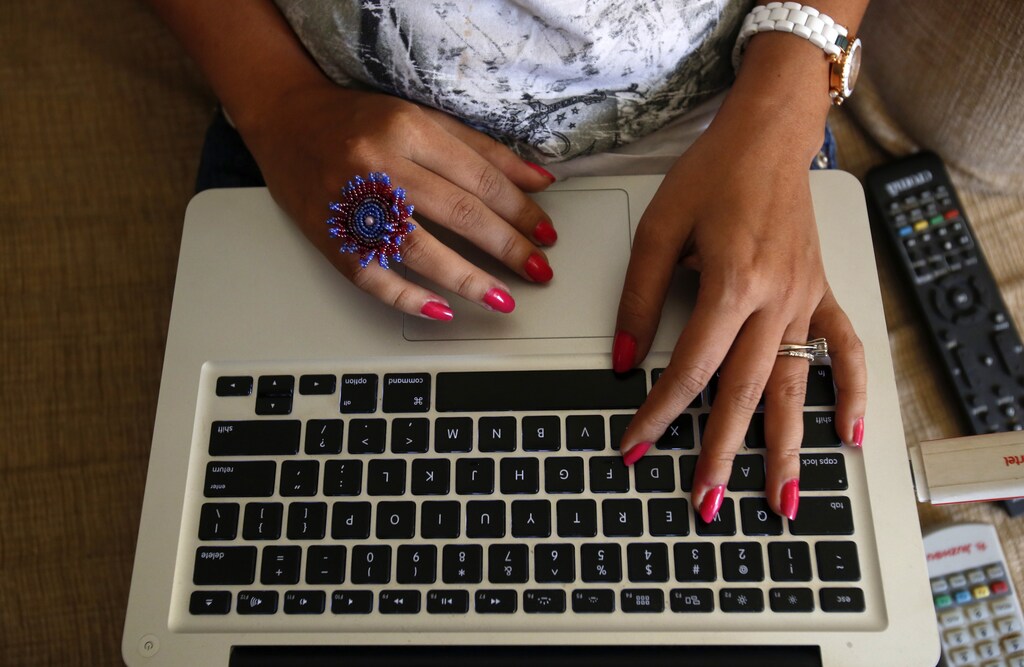 The hands of Malini Agarwal, blogger-in-chief of missmalini.com, are pictured as she blogs from her living room in Mumbai, January 22, 2013. Agarwal, 35, exemplifies what aspirational India is all about - She's bubbly, energetic, and describes herself as "India's blogging princess" and a "social media Jedi". She's been called "without a doubt, India's most famous blogger". Her blog, missmalini.com, gets over 250,000 unique visitors a month. It provides a steady diet of Bollywood gossip, fashion, food and entertainment to a legion of followers. REUTERS/Vivek Prakash (INDIA) - LM2E92B13VR01