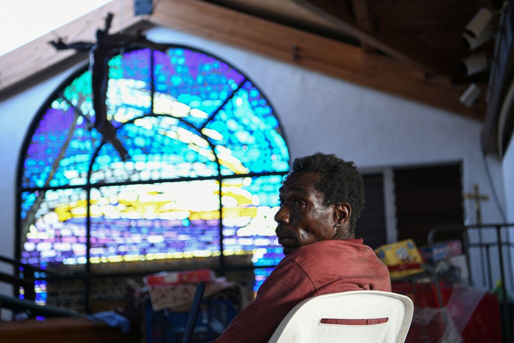 Abaco resident Berman Baptiste passes the time inside a damaged church serving as a shelter for people who lost their homes to Hurricane Dorian in Marsh Harbour, Great Abaco, Bahamas, September 8, 2019. REUTERS/Loren Elliott - RC1FC01A3870