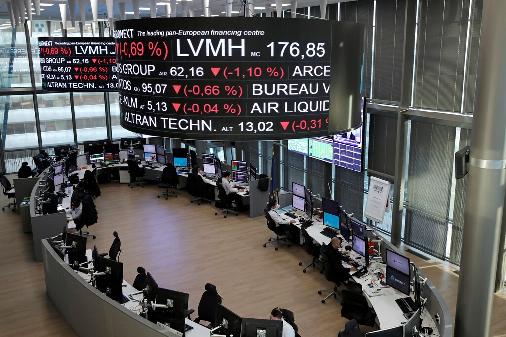 Company stock price information for LVMH Moet Hennessy Louis Vuitton SA, is displayed on screens as they hang above the Paris stock exchange, operated by Euronext NV, in La Defense business district in Paris, France, December 14, 2016. REUTERS/Benoit Tessier - RTX2V13L