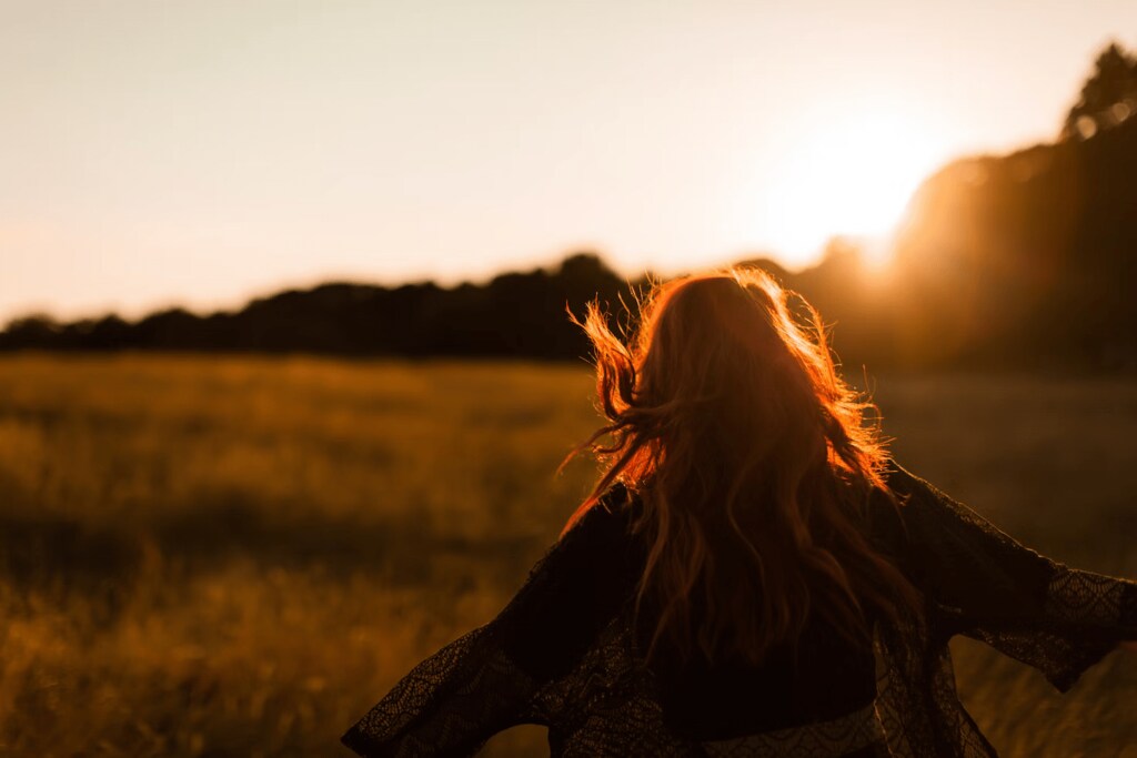 A person walking through a field alone.