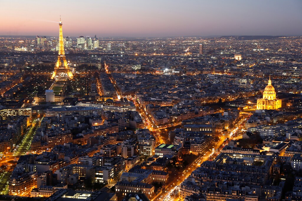A general view shows the illuminated Eiffel Tower (L), the Hotel des Invalides (R) and rooftops at night in Paris, France, November 28, 2016. REUTERS/Charles Platiau - RTSTTD0