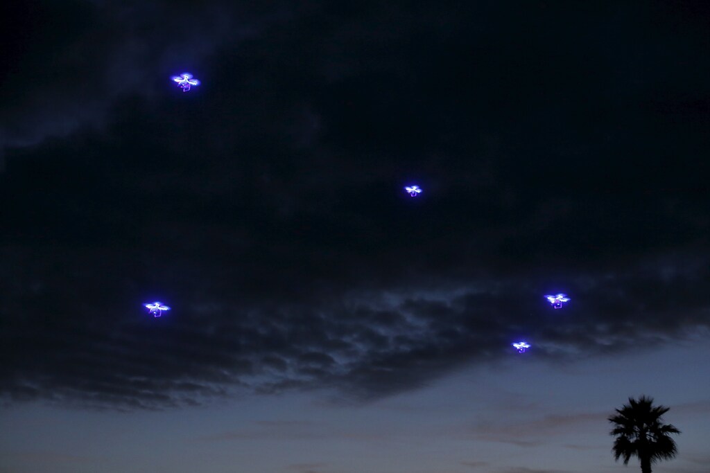 Drones fly in synchronization above attending conference goers as they dine outside along the ocean during the opening remarks at the beginning of the Wall Street Journal Digital Live ( WSJDLive ) conference at the Montage hotline Laguna Beach, California October 19, 2015. REUTERS/Mike Blake TPX IMAGES OF THE DAY - GF10000251478