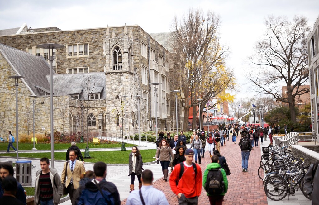 Students walk through the campus of Temple University, which has an enrollment of more than a 38,000 and offers 464 academic degree programs, in Philadelphia, Pennsylvania, U.S. on December 1, 2016. To match Special Report COLLEGE-CHARITIES/ REUTERS/Mark Makela - TM3ECC1196W01