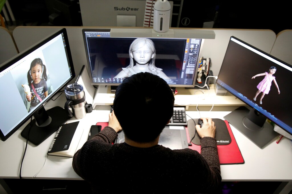 An employee works on avirtual reality modeling at the office of Vive Studios in Seoul, South Korea Tech technology science chemistry biology physics electricity electric power battery charge positive negative lab laboratory scientist fourth industrial revolution volt voltage change progress advancement power new revolution augmented reality virtual reality ar vr simulation south korea Korean mother daughter parent family