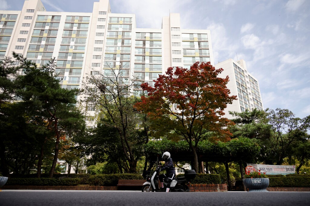 Chey Young-ah, a dispatch rider, checks her mobile phone as she chooses a delivery job in Seongnam, South Korea, October 7, 2020. Picture taken on October 7, 2020. REUTERS/Kim Hong-Ji - RC20IJ9MUGS2