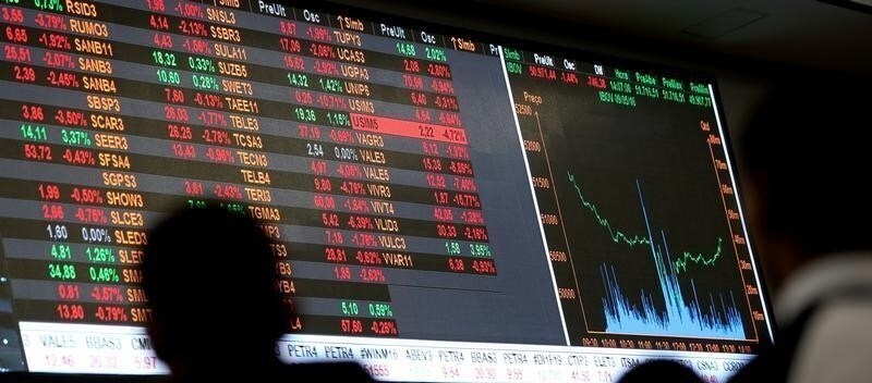 People look at an electronic board showing the graph of the recent fluctuations of market indices at the floor of Brazil's BM&F Bovespa Stock Market in downtown Sao Paulo, Brazil, May 9, 2016.