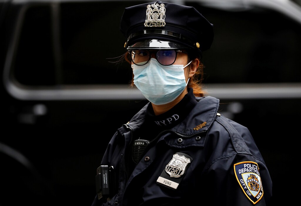 A member of the New York Police Department works during the outbreak of the coronavirus disease (COVID-19) in Manhattan, New York City, U.S., March 30, 2020. REUTERS/Andrew Kelly - Coronavirus china virus health healthcare who world health organization disease deaths pandemic epidemic worries concerns Health virus contagious contagion viruses diseases disease lab laboratory doctor health dr nurse medical medicine drugs vaccines vaccinations inoculations technology testing test medicinal biotechnology biotech biology chemistry physics microscope research influenza flu cold common cold bug risk symptomes respiratory china iran italy europe asia america south america north washing hands wash hands coughs sneezes spread spreading precaution precautions health warning covid 19 cov SARS 2019ncov wuhan sarscow wuhanpneumonia pneumonia outbreak patients unhealthy fatality mortality elderly old elder age serious death deathly deadly