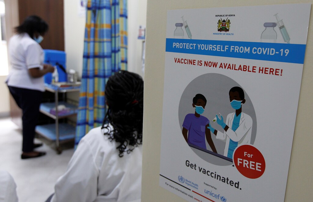 An advocacy poster is seen as a health worker waits to receive the AstraZeneca/Oxford vaccine under the COVAX scheme against coronavirus disease (COVID-19) at the Kenyatta National Hospital in Nairobi, Kenya March 5, 2021. REUTERS/Monicah Mwangi - RC215M9QSJ55