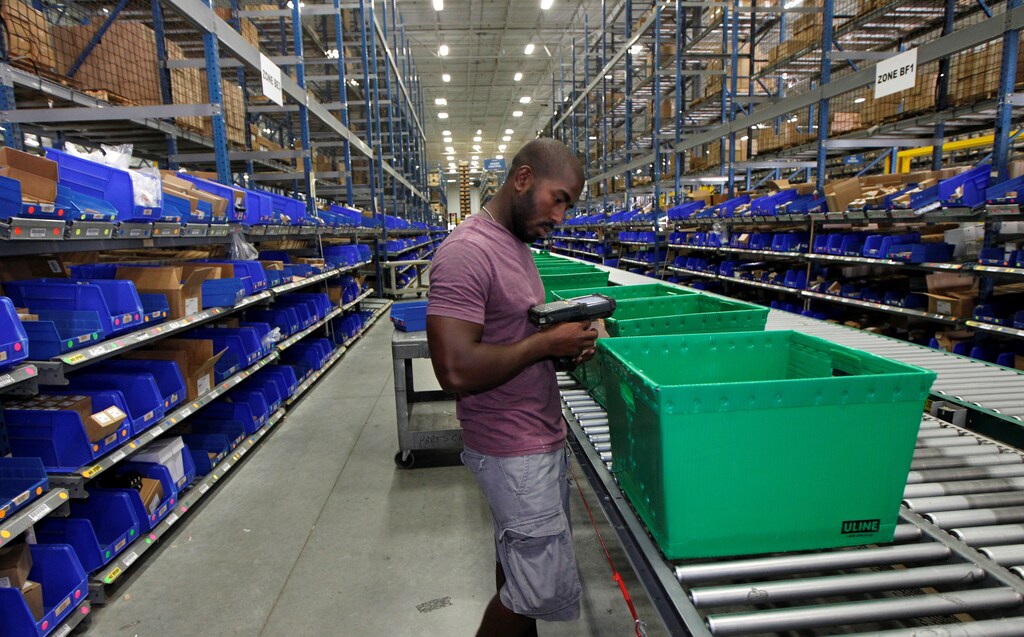 United Parcel Service employees Juan Carlos Mateo Amanico pull inventory for packaging at the UPS Supply Chain campus in Louisville, Kentucky, August 15, 2016. REUTERS/John Sommers II - RC16A69FBB10