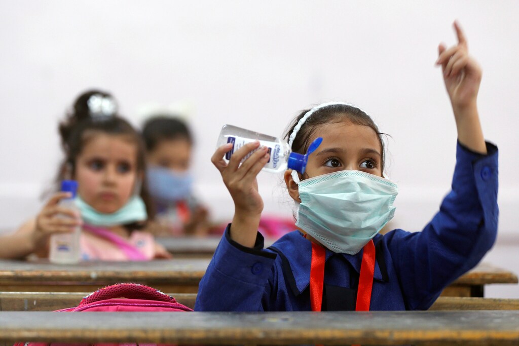 Refugee students learn how to sanitise their hands on the first day of the new school year at one of the UNRWA schools, amid fears of rising numbers of the coronavirus disease (COVID-19) cases in Amman, Jordan September 1, 2020