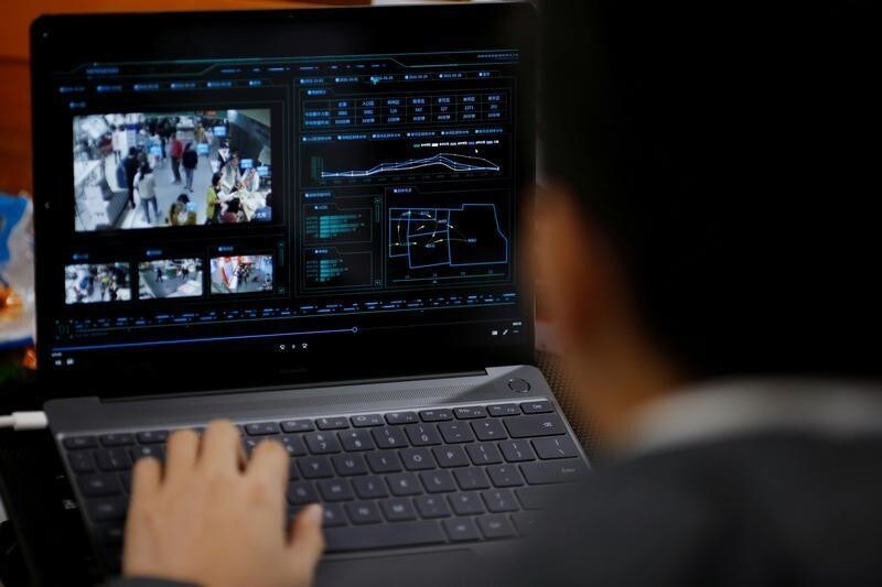 SenseTime Co-Founder Xu Chiheng demonstrates surveillance software of his company on a laptop at the SenseTime office in Beijing, China, October 11, 2017. Picture taken October 11, 2017.