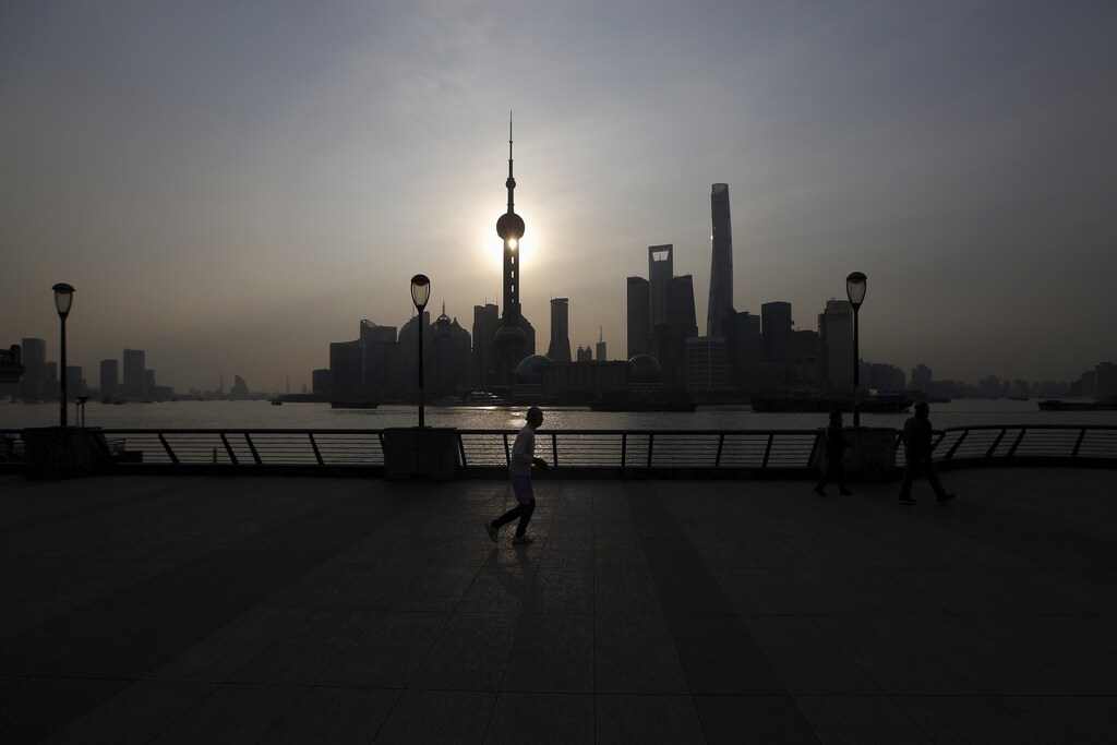 A man runs on the Bund in front of the financial district of Pudong in Shanghai, China, March 25, 2016. REUTERS/Aly Song - RTSC5JH
