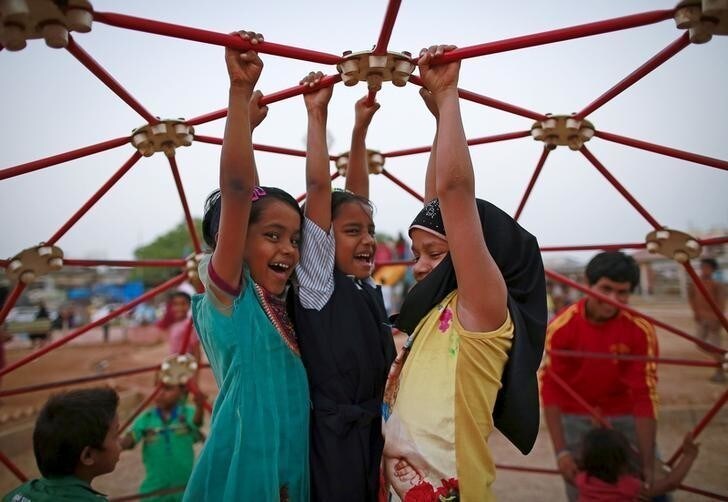 Girls play at a public park in Dharavi, one of Asia's largest slums, in Mumbai April 8, 2015. REUTERS/Danish Siddiqui