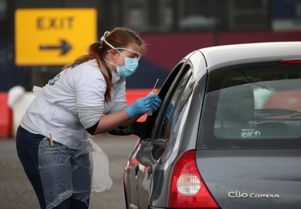 A staff member takes a sample at a COVID-19 testing centre amid the coronavirus disease outbreak, at Glasgow Airport, in Glasgow, Scotland April 29, 2020. Andrew Milligan/Pool via REUTERS