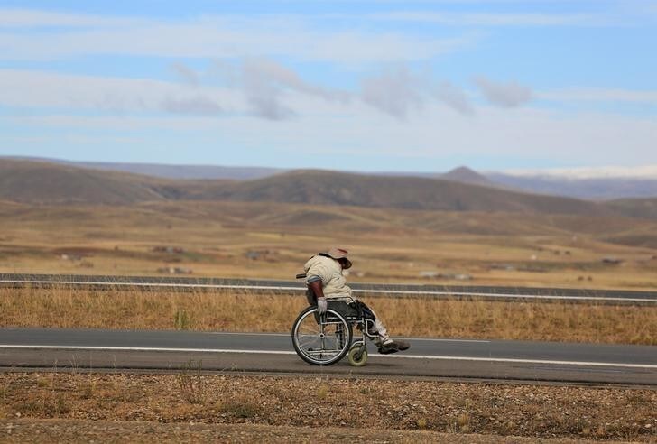 A man with physical disabilities participates in a protest march to demand that the government increase their monthly disability subsidy by 500 Bs, near Ayo Ayo, Bolivia April 20, 2016. REUTERS/David Mercado?