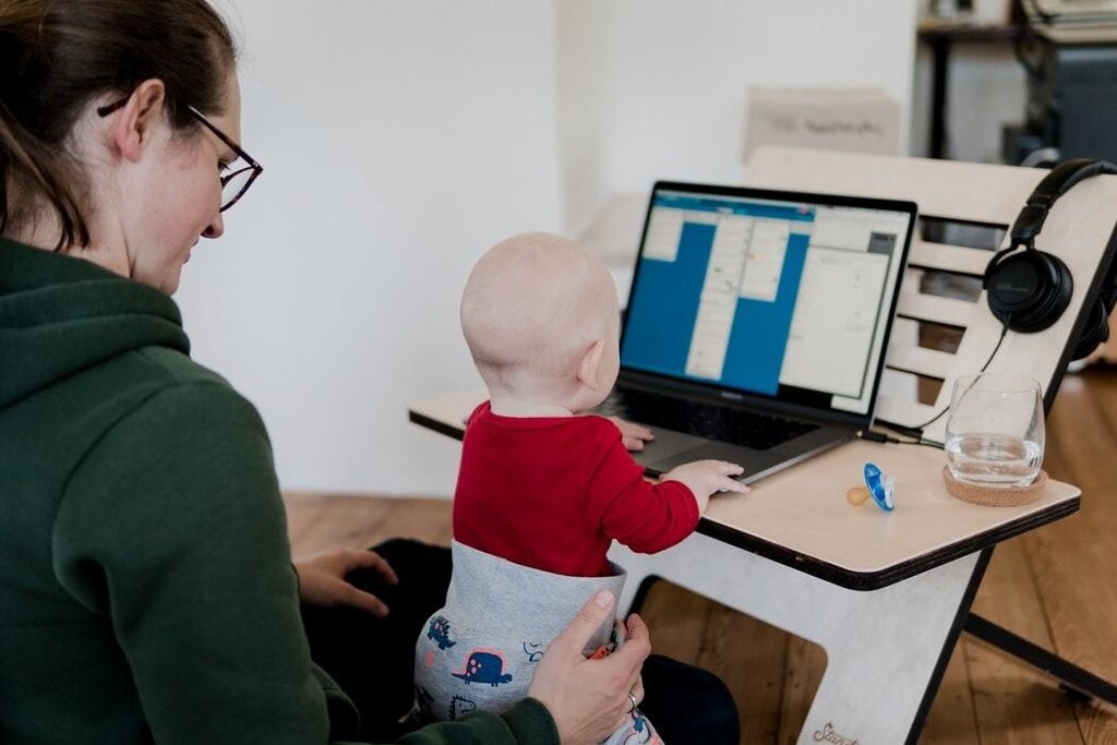 A mother working from home with her baby
