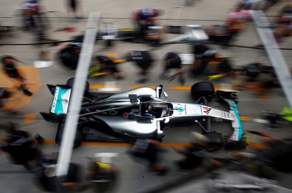 Formula One - F1 - Malaysia Grand Prix - Sepang, Malaysia- 29/9/16. Crew members push the car of Mercedes' Lewis Hamilton of Britain for a change of tyres.