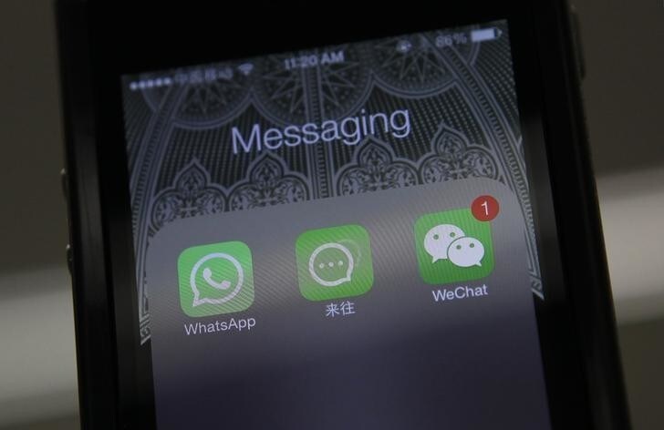 Icons of messaging applications WhatsApp of Facebook (L), Laiwang of Alibaba Group (C) and WeChat, or Weixin, of Tencent Group, are seen on the screen of a smart phone on this photo illustration taken in Beijing February 24, 2014. While Alibaba Group Holding Ltd dominates in e-commerce, Tencent Holdings Ltd has taken over China's smartphone screens with its WeChat, or Weixin, social messaging platform. It's a battle that is being more closely watched after Facebook Inc's $19 billion WhatsApp buy, and puts the spotlight on Ma's mobile strategy, especially as Alibaba winds up for a mega IPO that could value the company at close to $130 billion. Picture taken February 24, 2014. REUTERS/Barry Huang (CHINA - Tags: BUSINESS SCIENCE TECHNOLOGY)