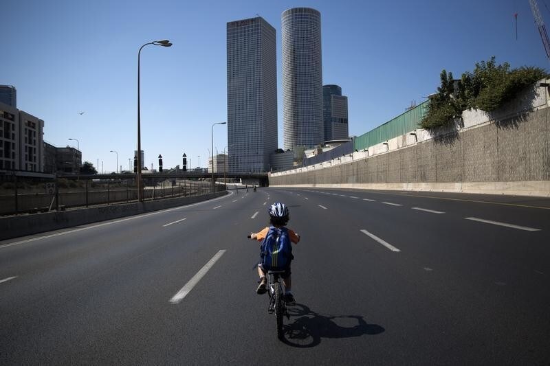 An Israeli boy rides his bike on an empty motorway during Yom Kippur in Tel Aviv, October 4, 2014. Many Israelis take to the streets on bicycles during the holiday of Yom Kippur, or the Day of Atonement, when the country comes to a standstill for 25-hours as observant Jews fast, businesses are closed, and driving is prohibited. REUTERS/Finbarr O'Reilly (ISRAEL - Tags: RELIGION SOCIETY TPX IMAGES OF THE DAY) - GM1EAA41H4601