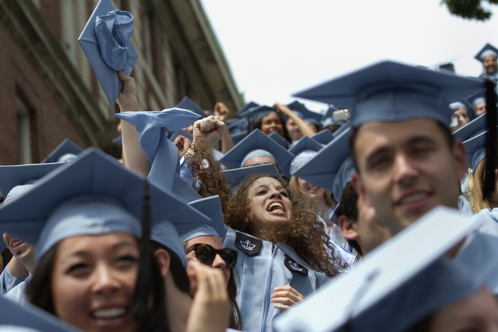 Graduates from Columbia University's School of Journalism cheer during the university's commencement ceremony in New York.