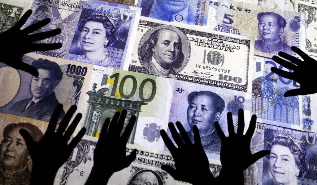 Hands are silhouetted against a backdrop projected with the picture of various currencies of money in this illustration taken April 4, 2016. REUTERS/Kacper Pempel/Illustration TPX IMAGES OF THE DAY - GF10000371147