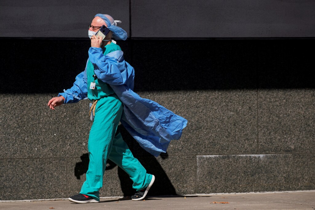 A doctor speaks on his phone outside the Emergency entrance to Maimonides Medical Center, as the spread of the coronavirus disease (COVID-19) continues, in the Borough Park neighborhood of Brooklyn, New York, U.S., October 14, 2020. REUTERS/Brendan McDermid - RC2OIJ9HBHCR