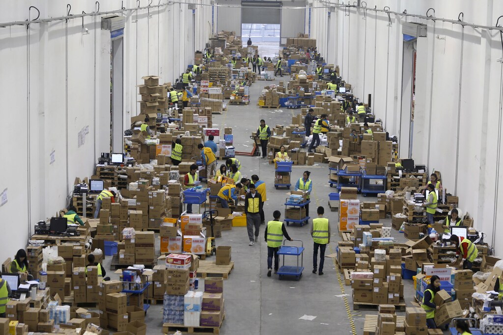 Employees sort boxes and parcels at the logistic centre of a express delivery company, after the Singles Day online shopping festival, in Wuhan, Hubei province, China, November 12, 2015. On China's giant Singles Day internet shopping festival, the country's delivery firms are stretched so thin that they are looking for tie-ups, listings and new investors to husband their resources. E-commerce has been a huge boon to the logistics industry, but the ever-bigger Singles Day, run by leading online market company Alibaba Group Holding Ltd on Nov. 11 every year, exacerbates the industry's twin dilemmas of cut-throat competition and rising labor costs. With low barriers to entry, express couriers proliferated rapidly over the past decade to more than 8,000 firms, squeezing profit margins to about 5 percent, down from 30 percent 10 years ago, according to analysts. Picture taken November 12, 2015. REUTERS/Stringer CHINA OUT. NO COMMERCIAL OR EDITORIAL SALES IN CHINA - RTS6QX6
