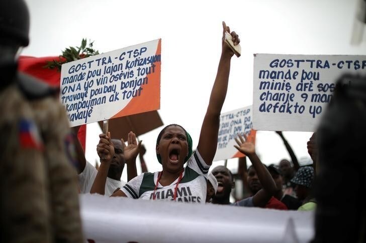 A woman reacts as workers gather to protest in Port-au-Prince, Haiti, June 11, 2018. REUTERS/Andres Martinez Casares
