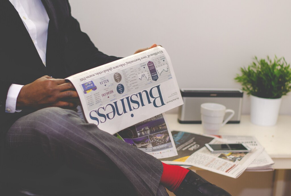 business man reading newspaper finance economy shareholder stakeholder capitalist