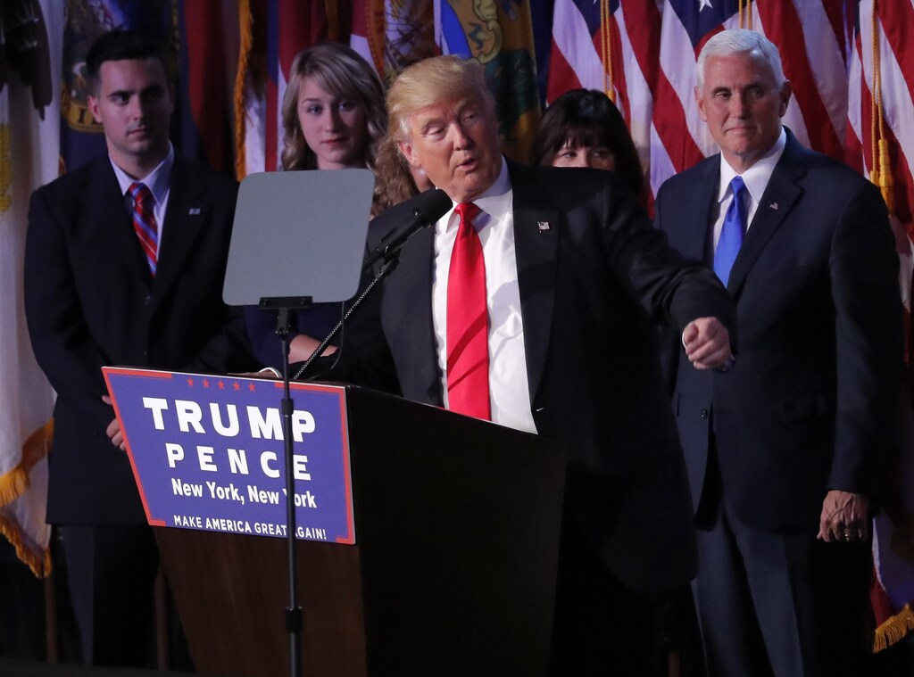 U.S. President-elect Donald Trump addresses supporters as Vice President-elect Mike Pence (R) looks on at Trump's election night rally in Manhattan, New York, U.S., November 9, 2016. REUTERS/Jonathan Ernst - RTX2SQ4L