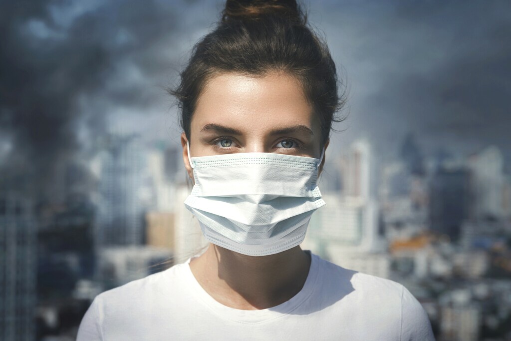 Clean air: Air pollution in the city. Woman wearing face mask for protection.
