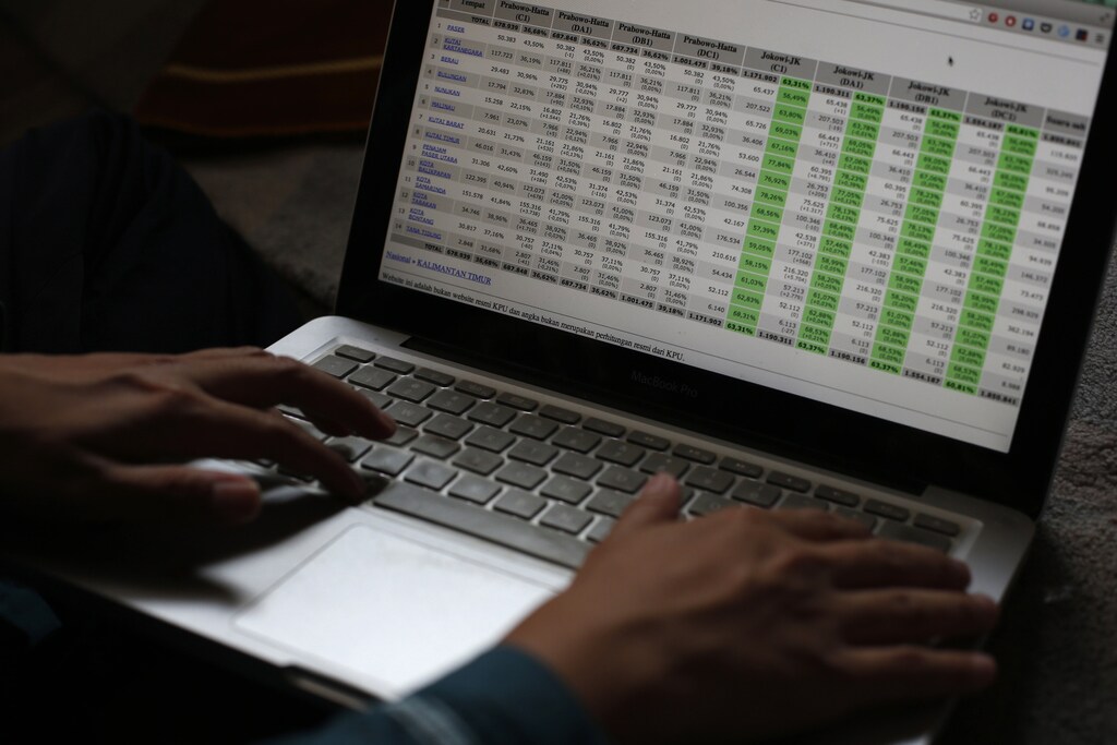 Ainun Najib, an Indonesian IT consultant based in Singapore, shows a table of voting results that was used in his work on the Indonesian elections as he waits to break fast at a friend's house during Ramadan in Singapore July 26, 2014.