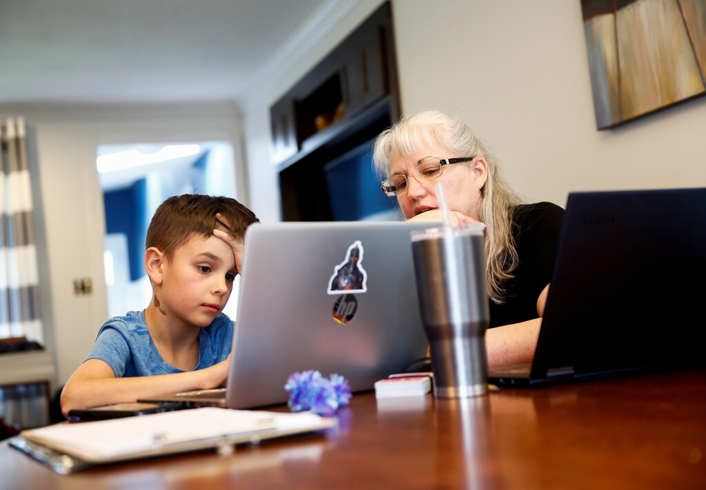 Caidence Miller, a 4th grader at Cottage Lake Elementary, works with his grandmother Chrissy Brackett as they try to figure out how to navigate the online learning system the Northshore School District will use for two weeks due to coronavirus concerns, at Brackett's home in Woodinville, Washington, U.S. March 11, 2020. Brackett is watching Caidence while Miller's mother works at a Bellevue preschool during the day. REUTERS/Lindsey Wasson - Coronavirus china virus health healthcare who world health organization disease deaths pandemic epidemic worries concerns Health virus contagious contagion viruses diseases disease lab laboratory doctor health dr nurse medical medicine drugs vaccines vaccinations inoculations technology testing test medicinal biotechnology biotech biology chemistry physics microscope research influenza flu cold common cold bug risk symptomes respiratory china iran italy europe asia america south america north washing hands wash hands coughs sneezes spread spreading precaution precautions health warning covid 19 cov SARS 2019ncov wuhan sarscow wuhanpneumonia pneumonia outbreak patients unhealthy fatality mortality elderly old elder age serious death deathly deadly