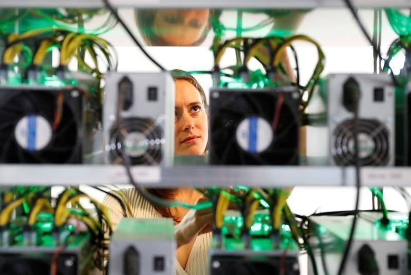 HydroMiner CEO Nadine Damblon checks cables on a miner at their cryptocurrency farming operation near Waidhofen an der Ybbs, Austria April 25, 2018. REUTERS/Leonhard Foeger - RC1BB7173AC0