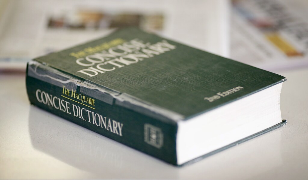 A photo illustration shows a 2nd edition copy of The Macquarie Concise Dictionary, the authority on the English language in Australia, on a coffee table in Sydney October 17, 2012. A fiery speech against sexism by Australia's first female Prime Minister Julia Gillard has prompted the textbook of Australian English to redefine the word "misogyny" to better fit the heated political debate raging downunder. REUTERS/Tim Wimborne (AUSTRALIA - Tags: POLITICS SOCIETY) - GM1E8AH1BKG01