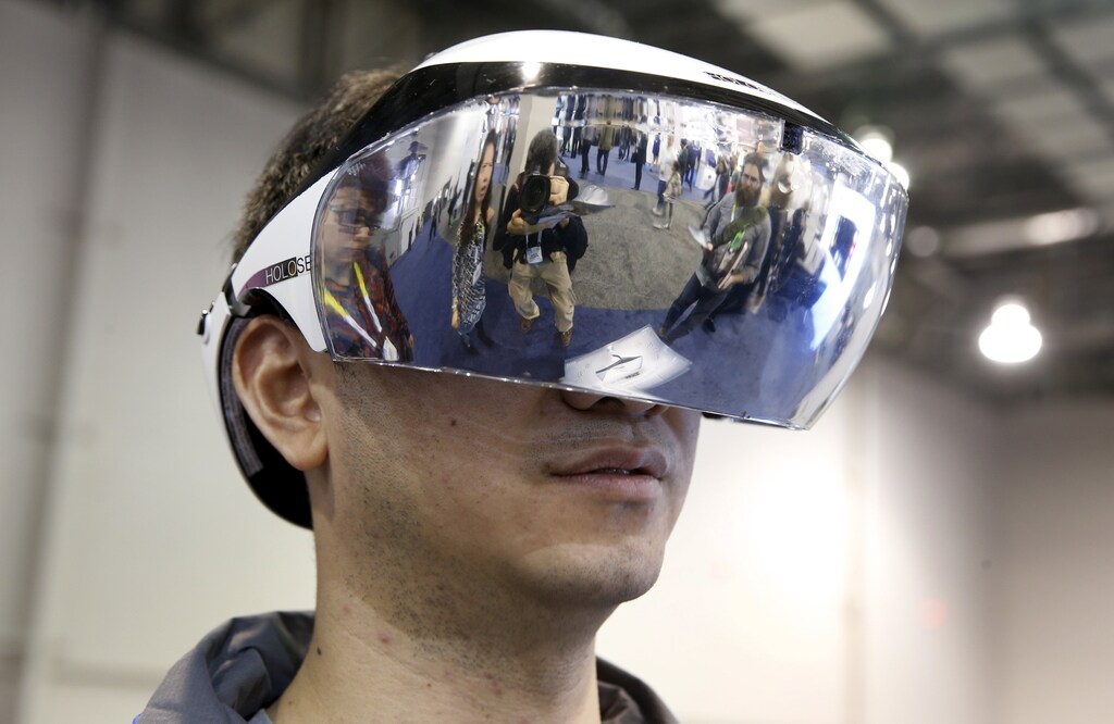 Kai Lee models a prototype Holoseer augmented-reality headset during the 2016 CES trade show in Las Vegas, Nevada January 8, 2016. The headset, with 100 degrees of view, is made by Caputer, a start-up company based in Shenzhen, China. REUTERS/Steve Marcus - GF20000088198