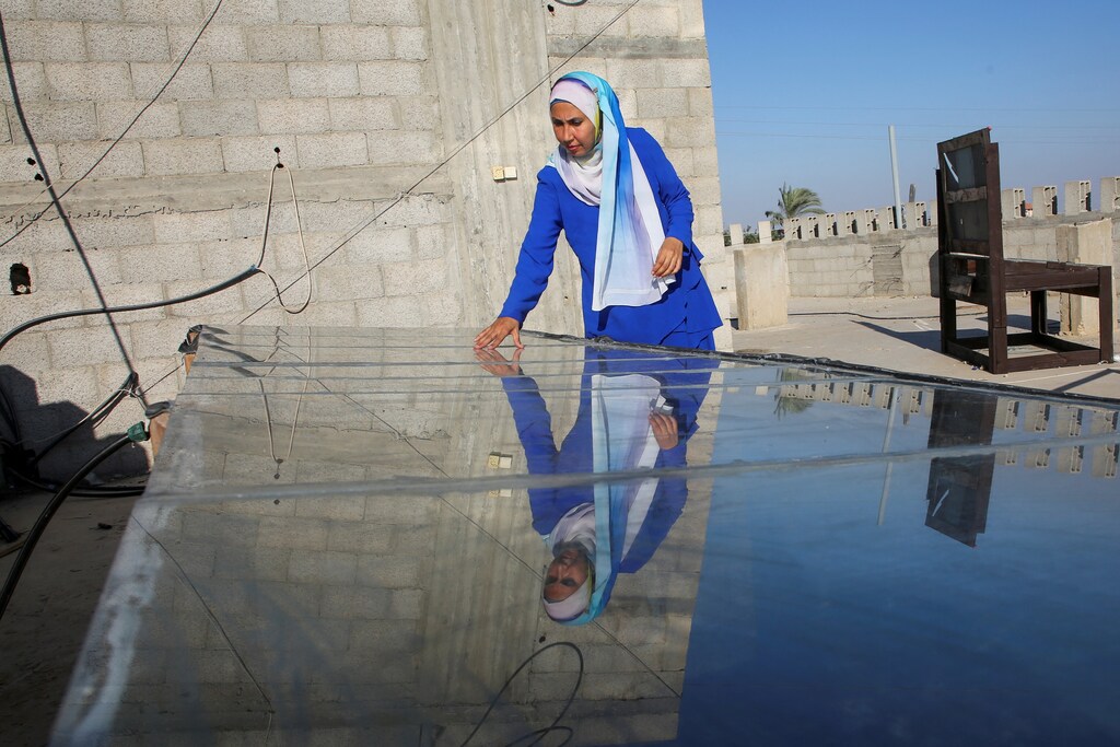 Inas Al-Ghoul, a Palestinian engineer, checks a solar water desalination system she built in response to a water crisis, as the Israel-Hamas conflict continues, in Khan Younis, in the southern Gaza Strip, September 7, 2024. REUTERS/Hatem Khaled. green skills