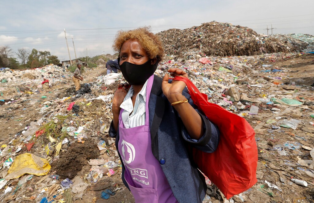 Julia Wanja, a hair stylist, carries bags of women's hair extensions to be recycled from the Dandora dumpsite, amid the coronavirus disease (COVID-19) outbreak in Eastlands Nairobi, Kenya July 29, 2020. Picture taken July 29, 2020. REUTERS/Thomas Mukoya - RC2Y6I9BUWER