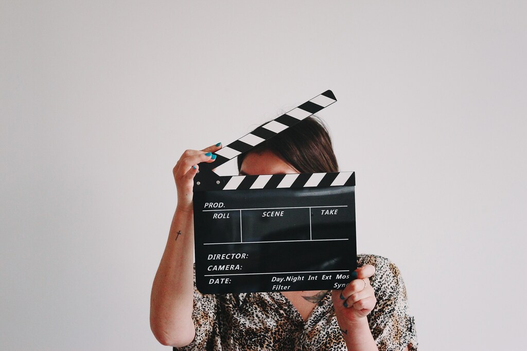 Woman holding a clapperboard