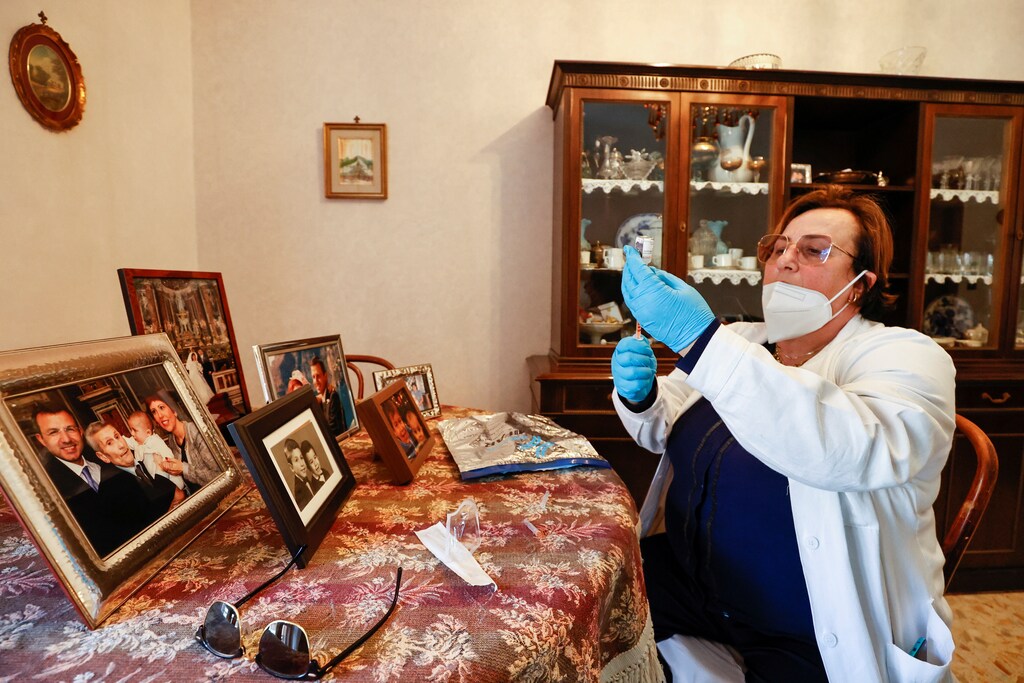 image of doctor Pina Tomaselli prepares a syringe containing a dose of the Moderna coronavirus disease (COVID-19) vaccine at a care home in Naples, Italy