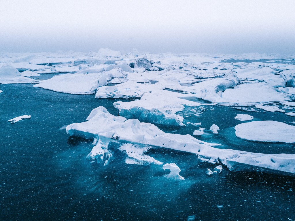 Arctic view of ice-bergs broken above water.
