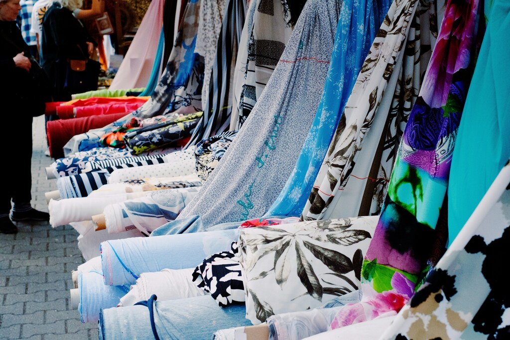 A row of colourful fabric rolls: The textile industry can lear from e-waste to help drive it towards a circular economy.