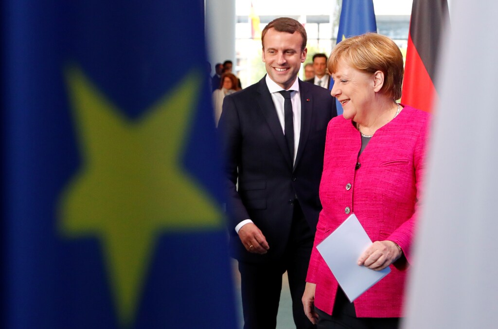 German Chancellor Angela Merkel and French President Emmanuel Macron arrive to a news conference at the Chancellery in Berlin, Germany, May 15, 2017. REUTERS/Fabrizio Bensch - RTX35YLH